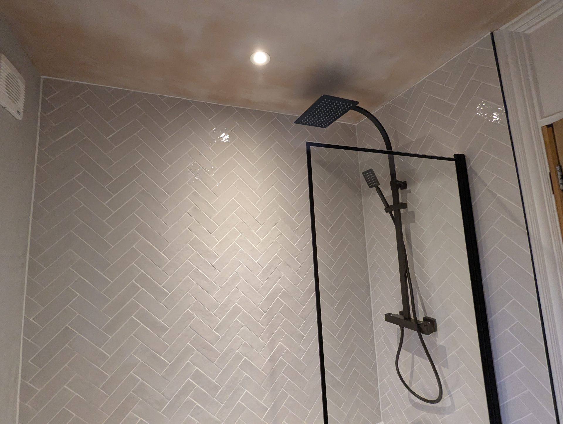 Herringbone tiled bathroom renovation with modern vanity unit in Nuneaton