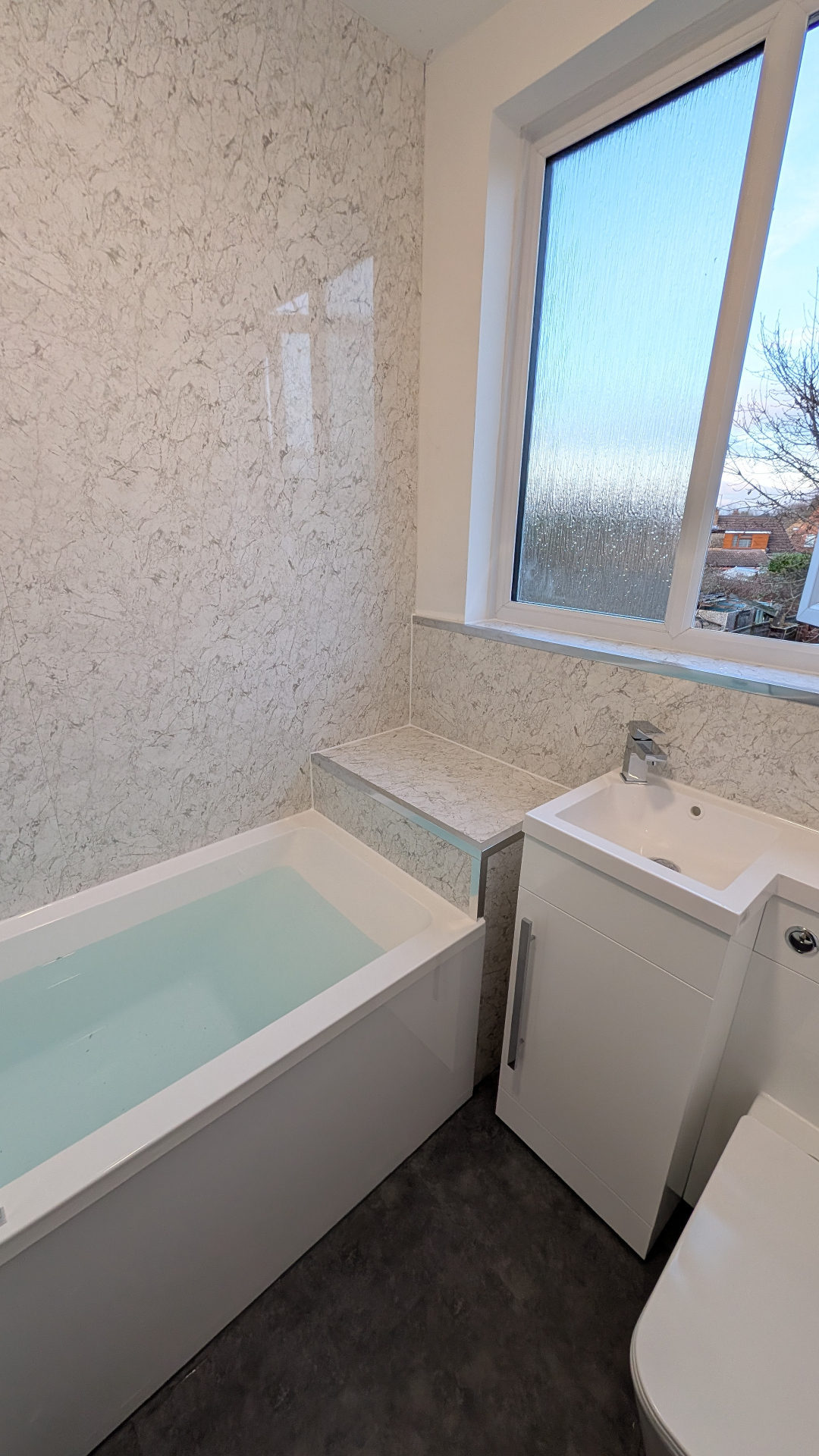 Marble-effect bathroom renovation with freestanding bath completed by Central One