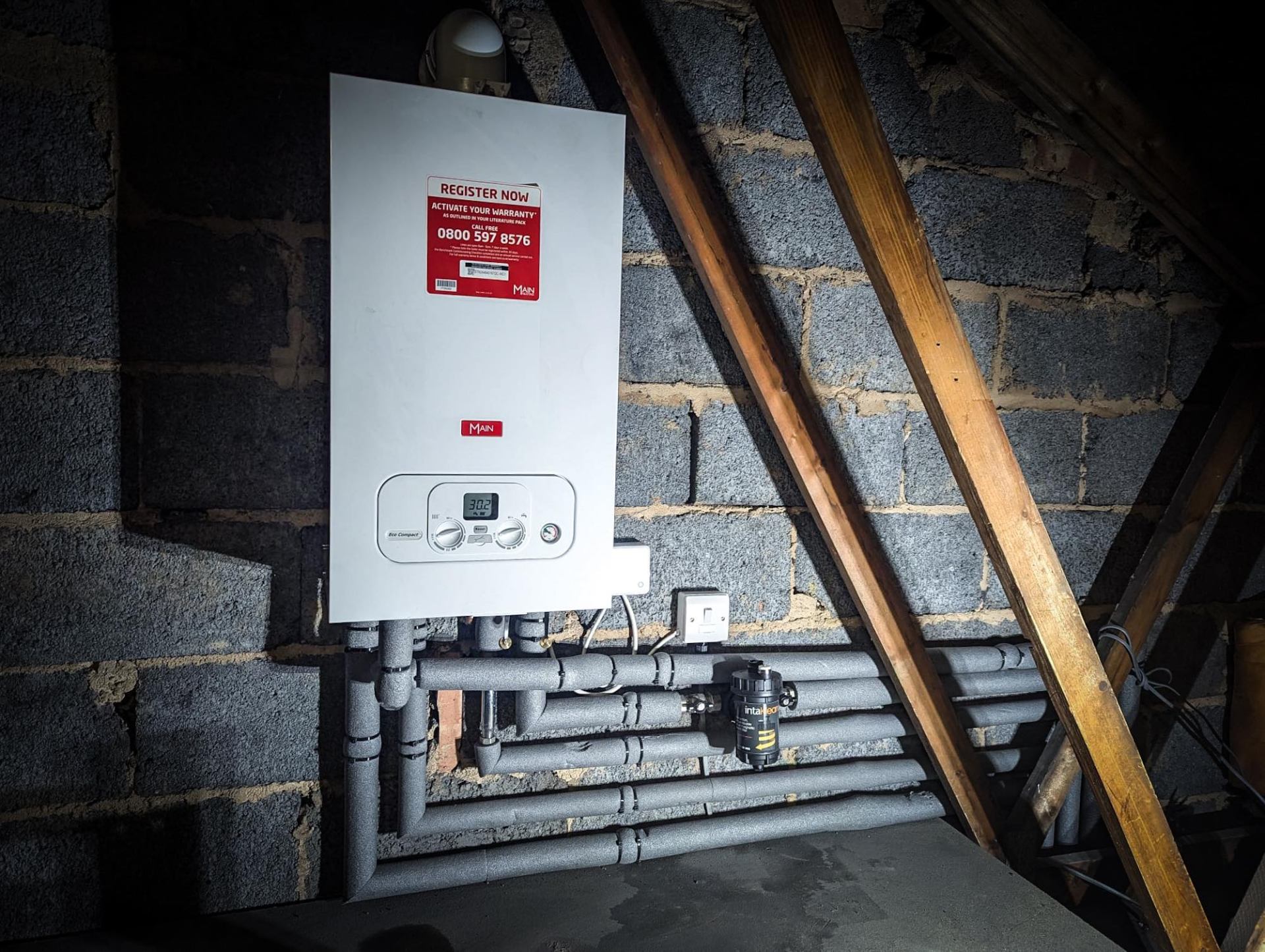 Engineer carrying out annual boiler service with diagnostic equipment